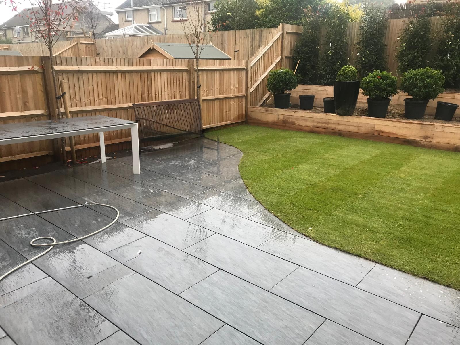 Finished garden with curved slate patio and fresh lawn